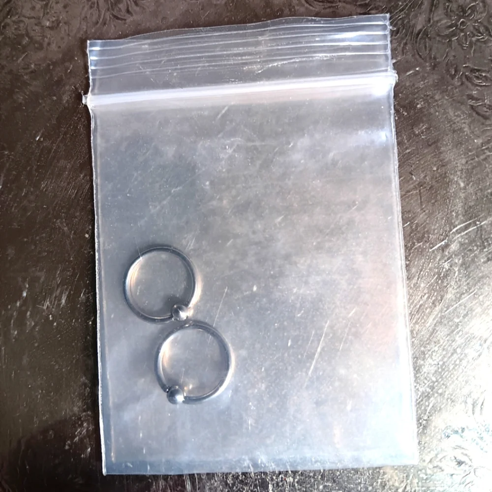 New 2 nose rings or 1 pair ear rings